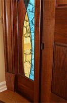 Black Walnut Entranceway with Stained Glass Surround - close up of molding surround and sidelight leaded window